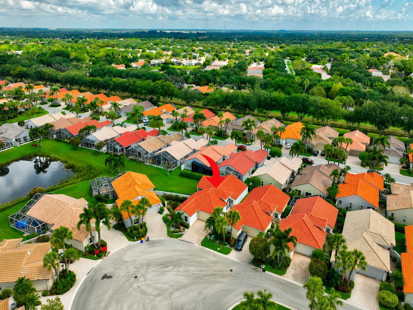 An aerial view of a residential neighborhood featuring houses with orange tile roofs and pools — 7169 Foxworth Court, Boynton Beach FL 33437, BOYNTON BEACH, FL