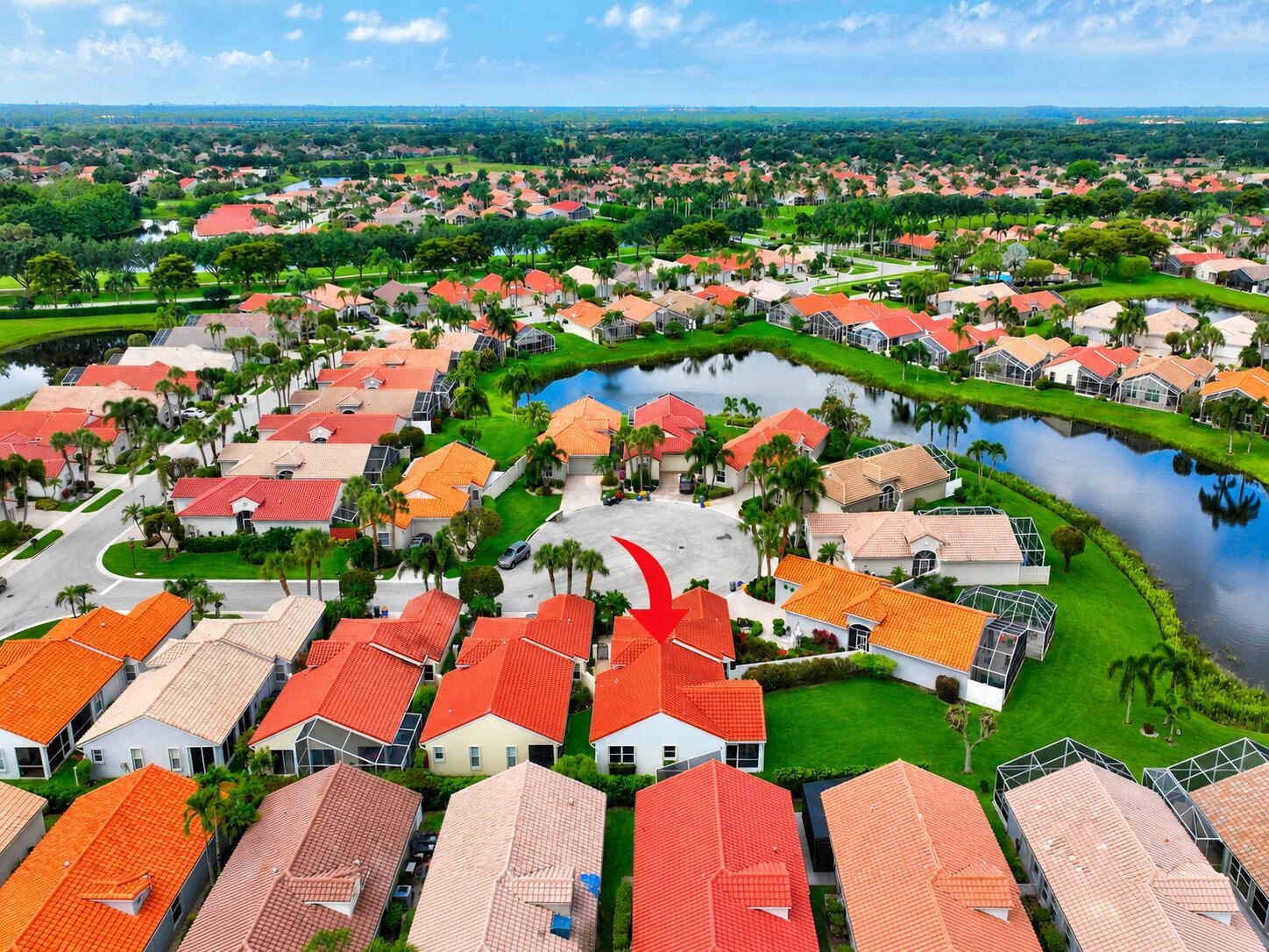 An aerial view of a suburban neighborhood featuring houses with orange tile roofs and ponds — 7169 Foxworth Court, Boynton Beach FL 33437, BOYNTON BEACH, FL