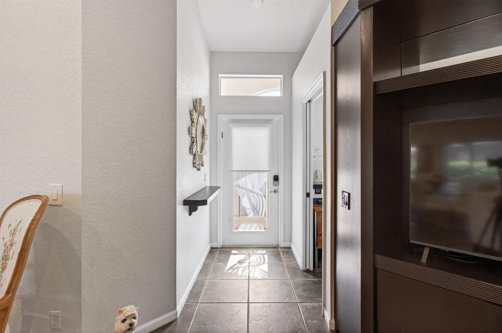 A tiled entryway features a white door with a transom window and a floating shelf — 7169 Foxworth Court, Boynton Beach FL 33437, BOYNTON BEACH, FL
