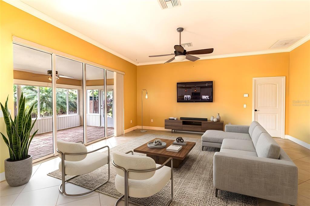 A living room features yellow walls, a gray sectional sofa, two chairs, and sliding glass doors — 3715 SEBRING PARKWAY, SEBRING, FL