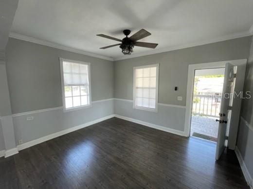 A porch features a tiled floor, a black door, a white door, and two windows — 1211 1/2 E 17TH AVENUE, TAMPA, FL