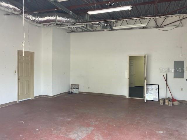 An interior view of a commercial space with a concrete floor, white walls, and exposed ceiling — 5001 S MACDILL AVENUE UNIT 100, TAMPA, FL