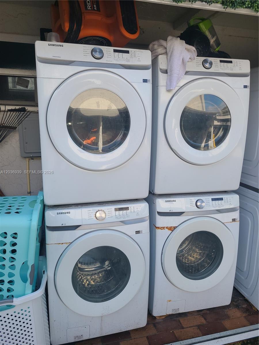 Four white Samsung laundry machines are stacked in pairs outdoors on a paved surface — 168 NW 32nd St # 6, Miami FL 33127, MIAMI, FL