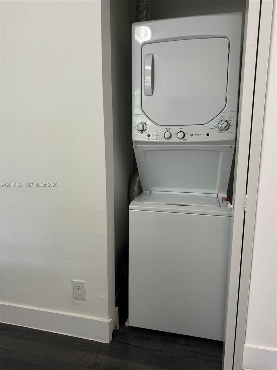 A white stacked washer and dryer unit is installed in a closet — 1842 Madison St # 2, Hollywood FL 33020, HOLLYWOOD, FL
