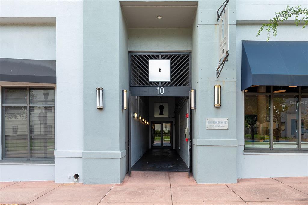 The exterior entrance of a building features a central walkway marked with the number ten — 10 N SUMMERLIN AVENUE UNIT 14, ORLANDO, FL