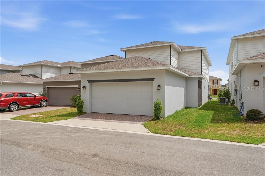 The exterior view shows a two-story house with a white garage and a red car — 3979 CAPITAL REEF WAY, APOPKA, FL