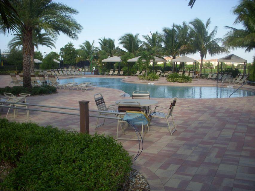 A swimming pool with lounge chairs and shaded cabanas on a paved patio area — 8887 Chestnut Ridge Way, Boynton Beach FL 33473, BOYNTON BEACH, FL