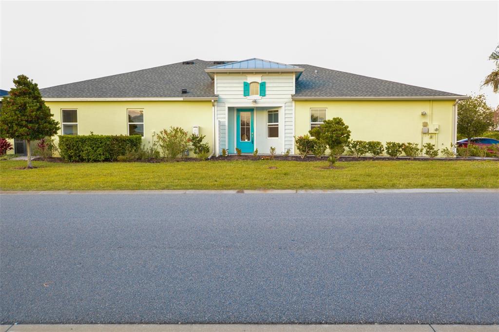 A pale yellow single-story house with a bright blue front door and matching shutters — 544 LOST SHAKER WAY, DAYTONA BEACH, FL