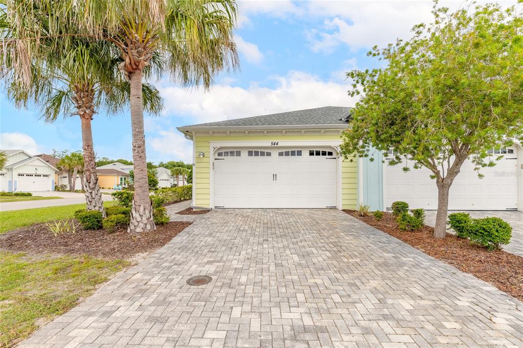 A light yellow house with a white garage door and a paved driveway — 544 LOST SHAKER WAY, DAYTONA BEACH, FL