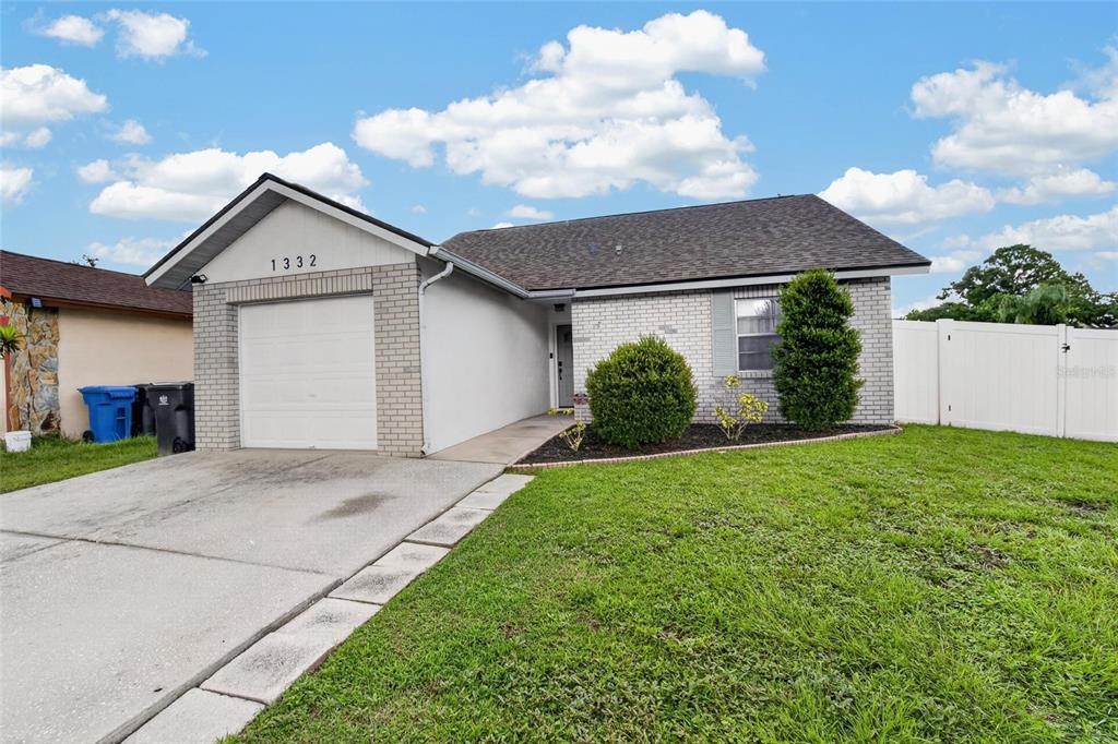 A single-story house with a brick facade, a one-car garage, and a front lawn — 1332 COOLRIDGE DRIVE, BRANDON, FL