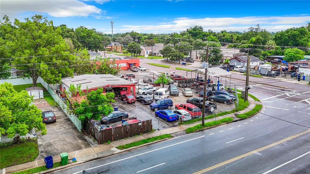 An aerial view shows a commercial auto repair shop with a parking lot full of cars — 1412 E LAKE AVENUE, TAMPA, FL