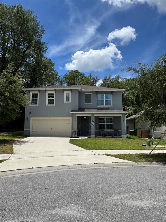 A two-story gray house with a two-car garage and a covered front porch — 325 CHARLES DRIVE, DELAND, FL