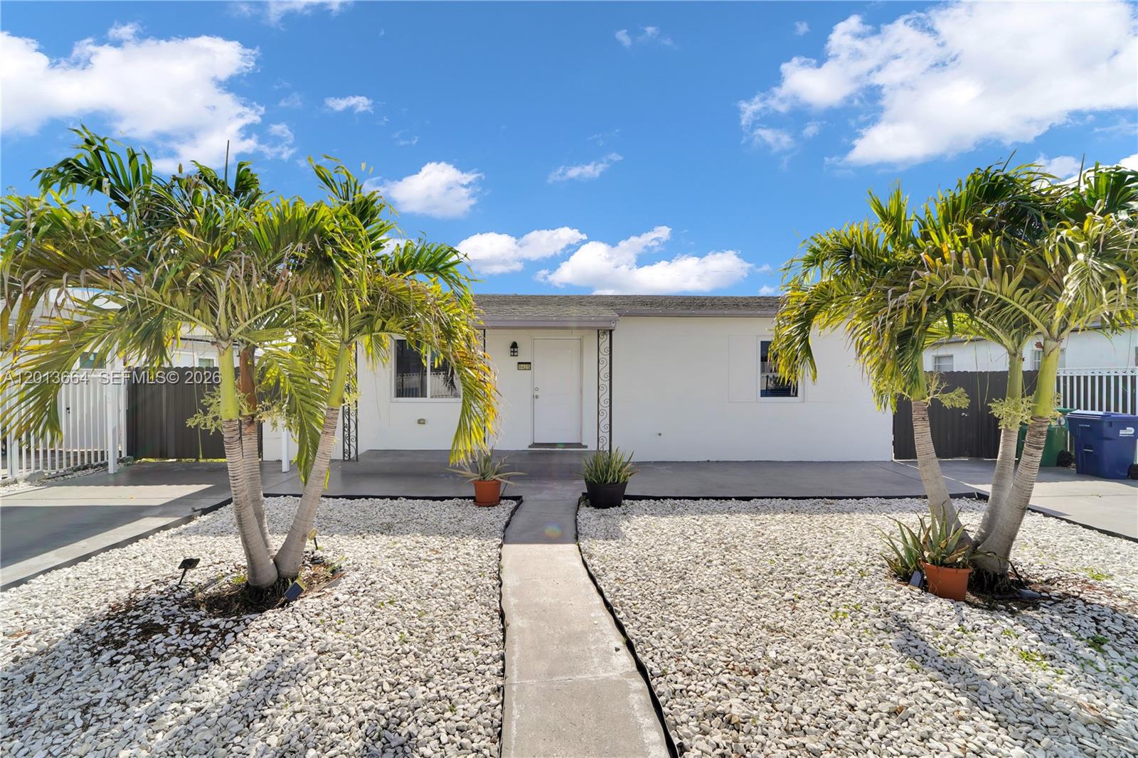 A single-story white house features a gravel front yard with two palm trees — 9425 NW 36th Ave, Miami FL 33147, MIAMI, FL