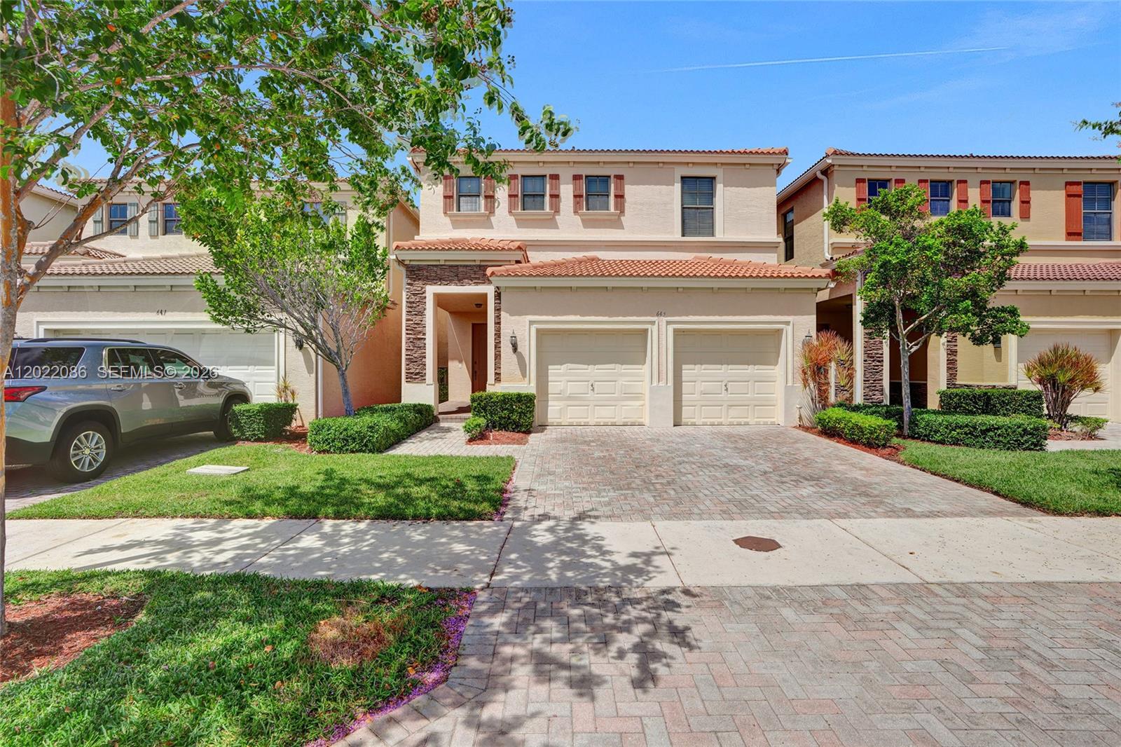 A two-story suburban house with a two-car garage and a paved driveway — 643 NE 191st Ter, Miami FL 33179, MIAMI, FL
