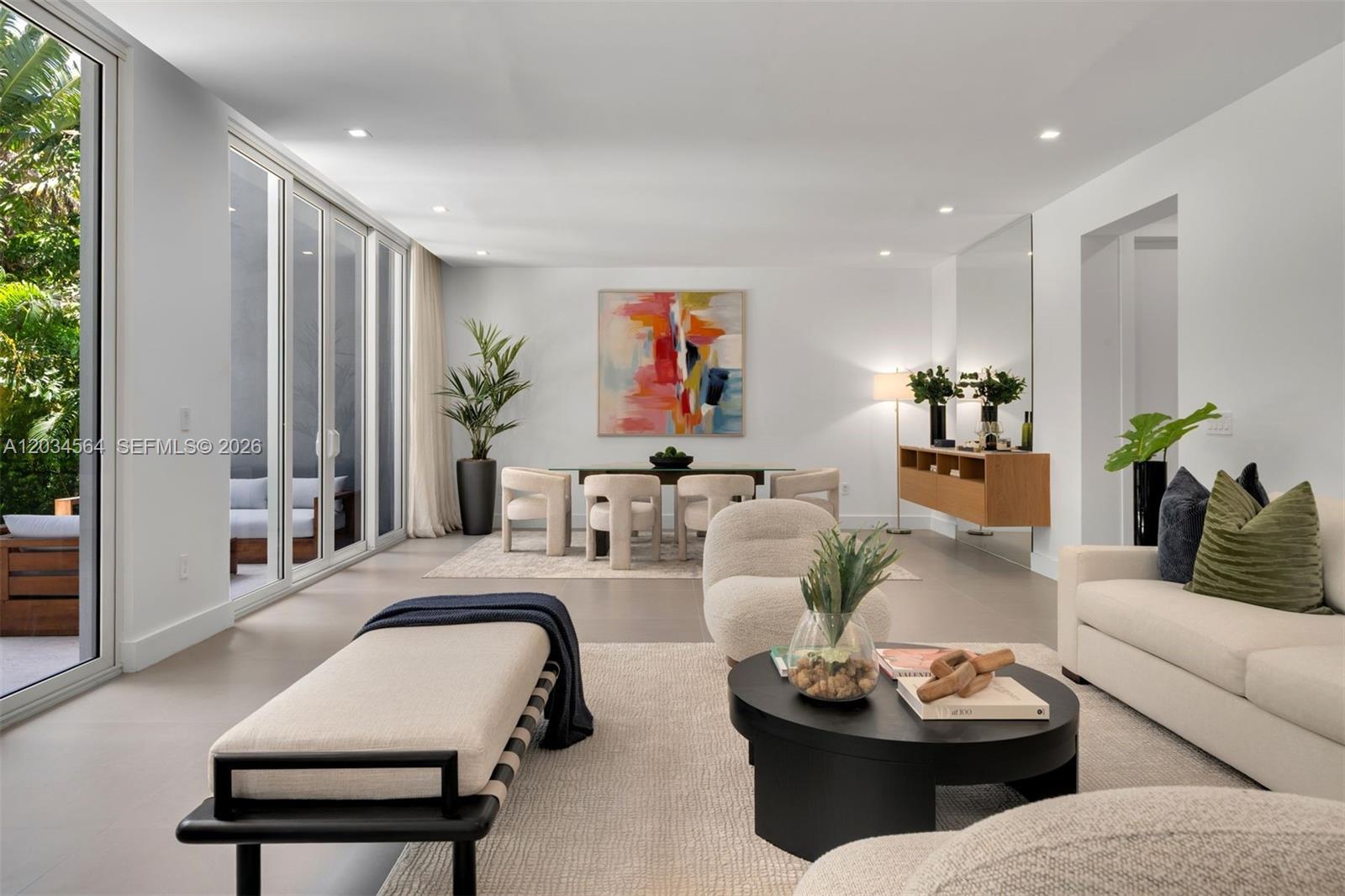 A bright, open-concept living and dining area features modern furniture, neutral tones, and floor-to-ceiling windows — 425 Harbor Dr, Key Biscayne FL 33149, KEY BISCAYNE, FL
