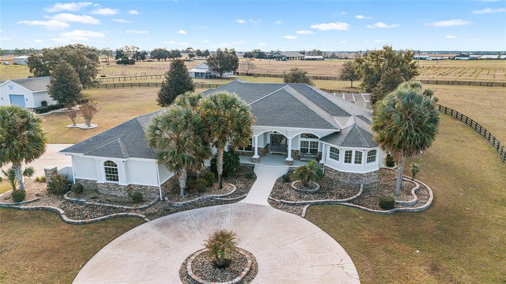 An aerial view of a single-story house with a circular driveway and palm trees — 2655 NW 102ND BOULEVARD, WILDWOOD, FL
