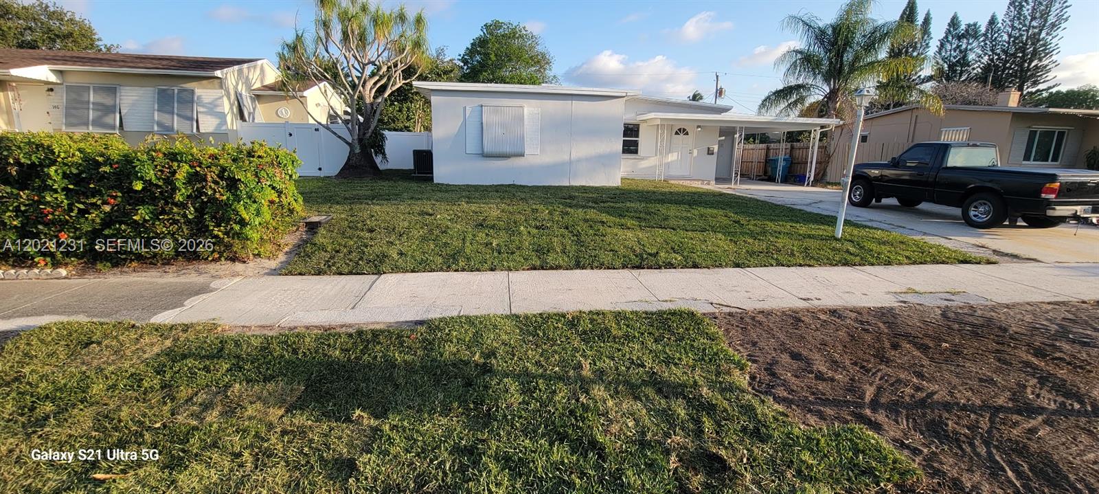 A single-story house with a white exterior, a front lawn, and a driveway with a truck — 142 SE 4th ave, Boynton Beach FL 33435, BOYNTON BEACH, FL