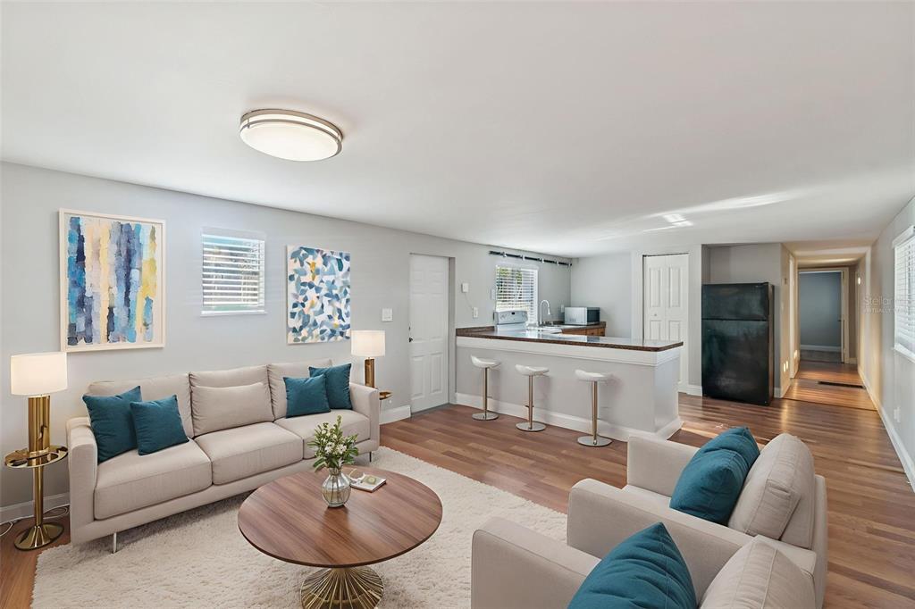 A living room with a sofa, armchairs, and an open kitchen with a breakfast bar — 5464 S WILSON POINT, HOMOSASSA, FL