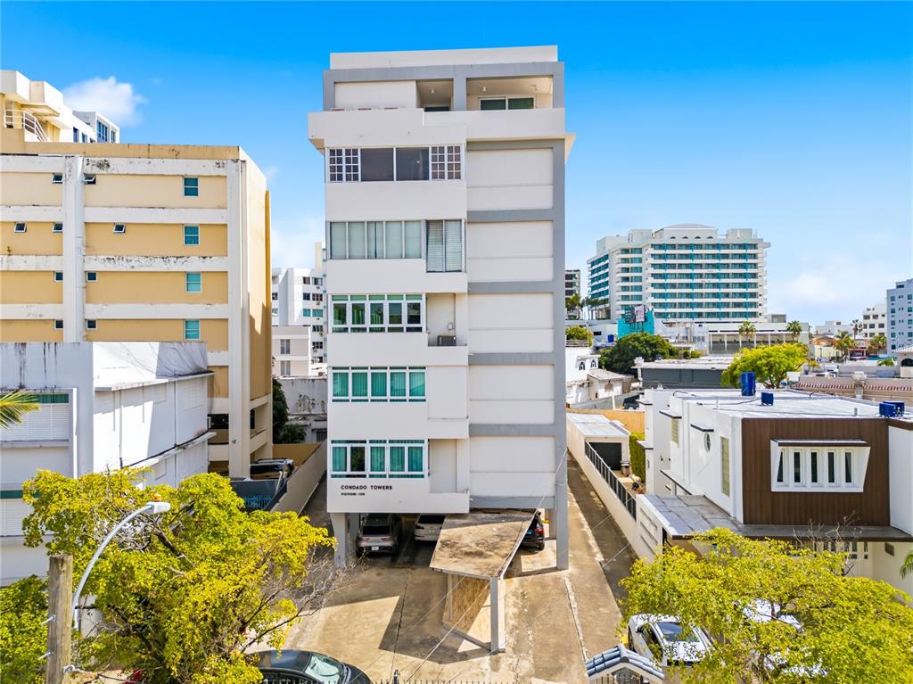 An exterior view of a multi-story apartment building with a ground-level parking area — 1115 PICCIONI UNIT 3A, SAN JUAN, PR