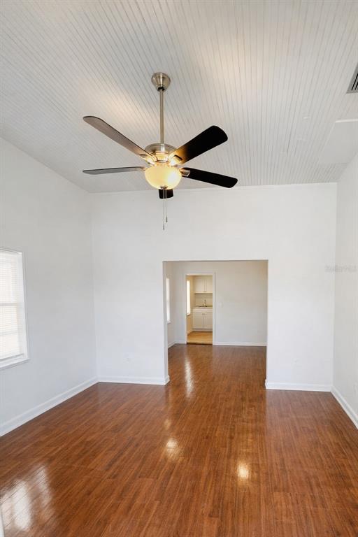 A room with wood-look flooring, white walls, a beadboard ceiling, and a ceiling fan — 2507 ARMENIA, TAMPA, FL