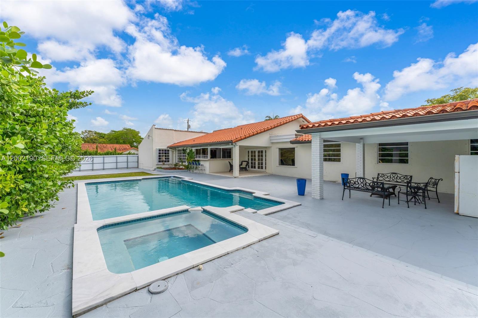 A backyard features a swimming pool, a hot tub, and a covered patio area — 11350 SW 30th St, Miami FL 33165, MIAMI, FL