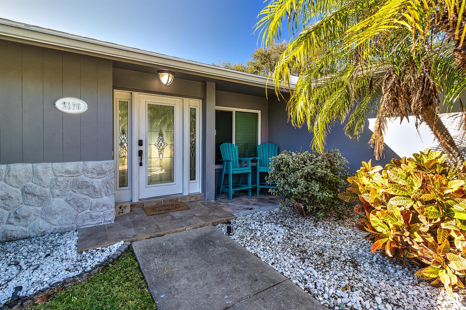 A backyard features a swimming pool with an attached hot tub, patio, and palm tree — 2376 Armour Drive, FL 34698, FL