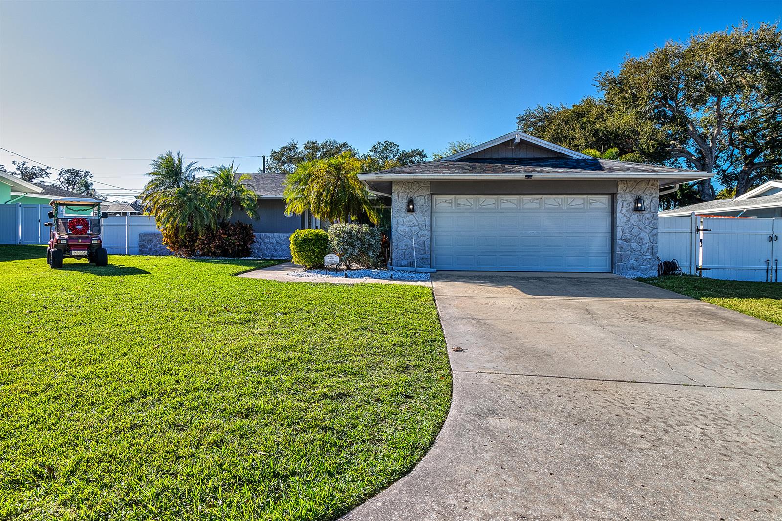 A living room with a beige sofa, coffee table, and sliding doors opening to a patio — 2376 Armour Drive, FL 34698, FL
