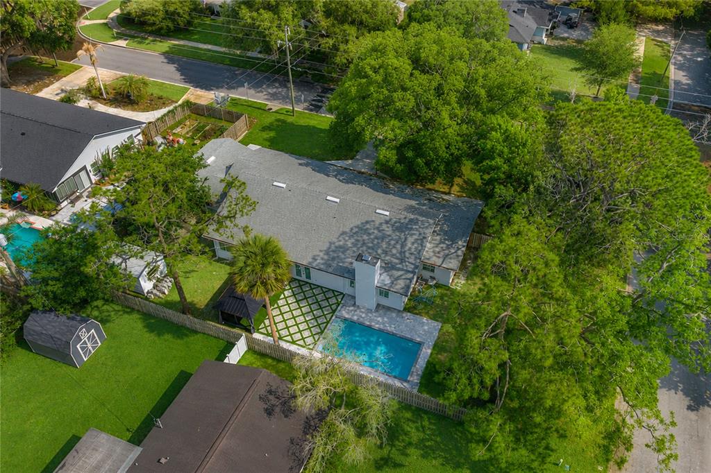 An aerial view shows a house with a gray roof, a pool, and a backyard — 20 E DIVISION STREET, WINTER GARDEN, FL