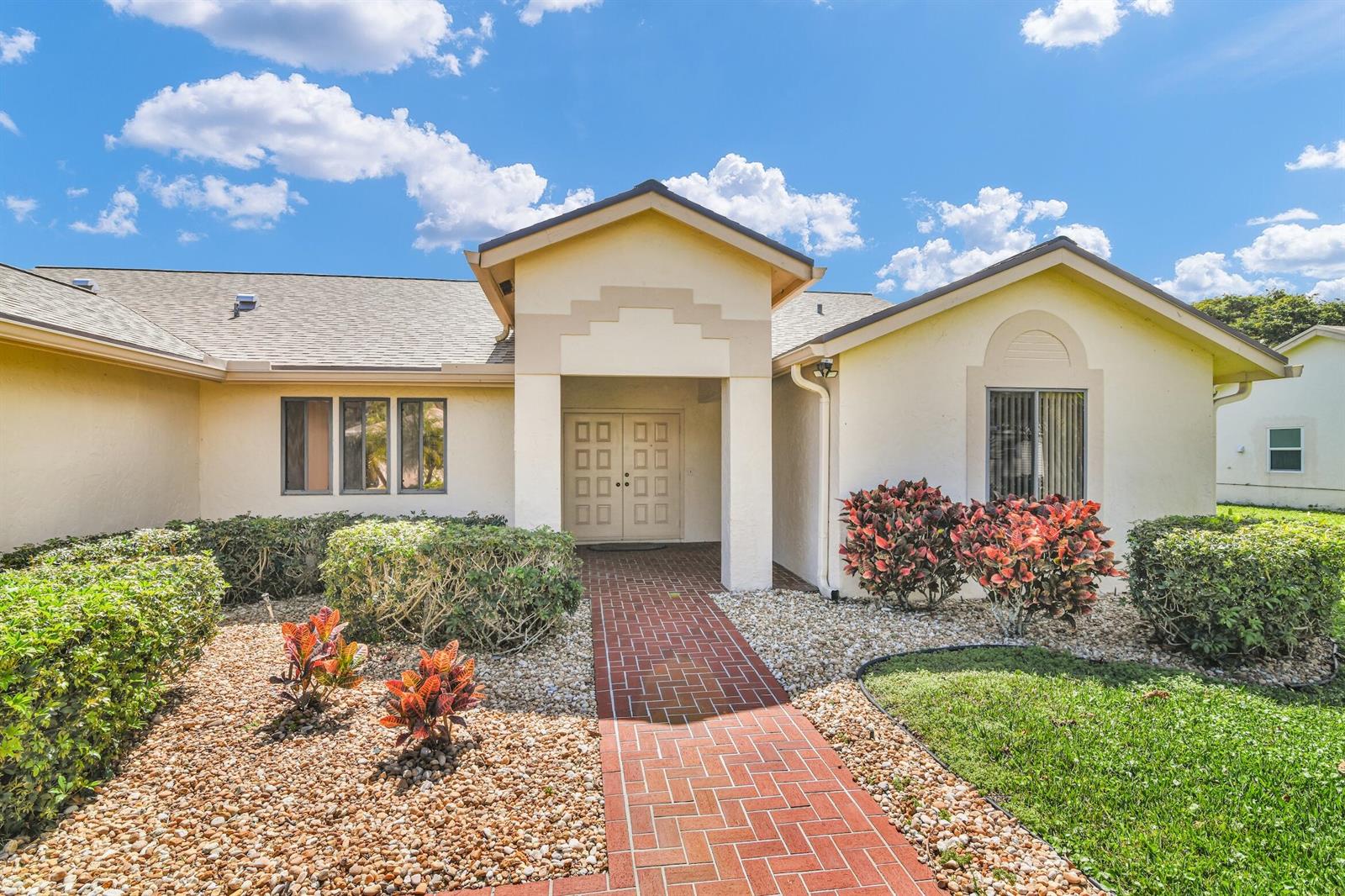 A single-story house with a brick walkway leading to a double front door entrance — 2660 Riviera Drive, Delray Beach FL 33445, DELRAY BEACH, FL