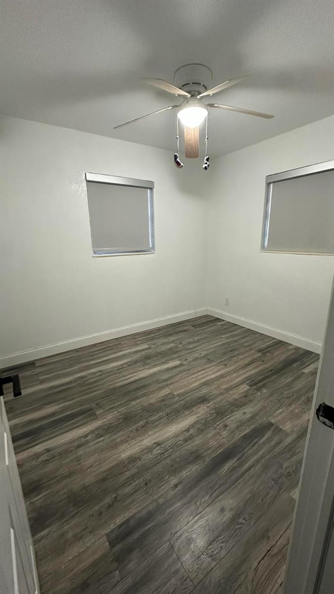 An empty bedroom features white walls, a ceiling fan, and wood-look plank flooring — 4628 SW 32nd Drive, West Park FL 33023, WEST PARK, FL