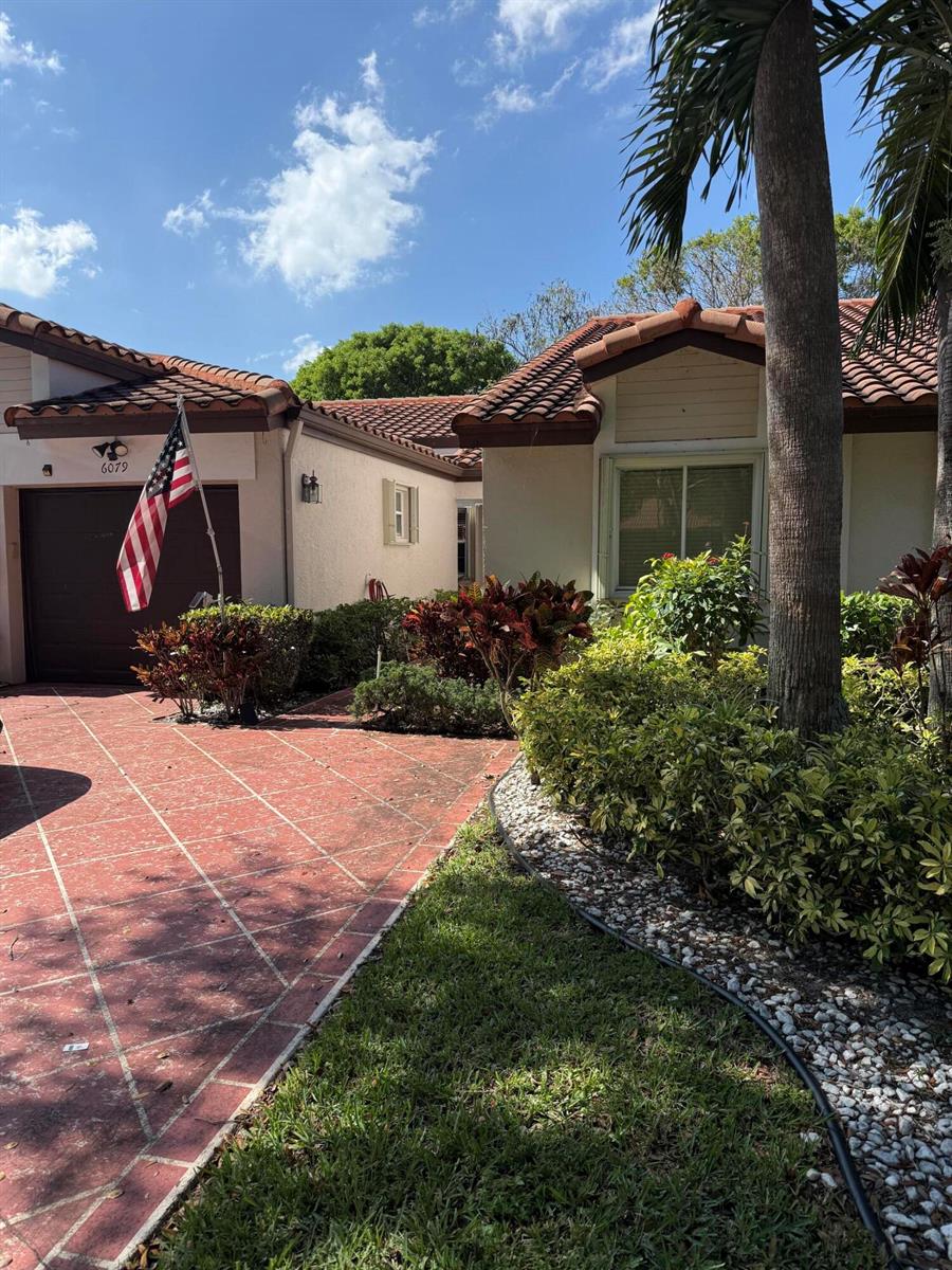 A single-story house with a red tiled roof, a paved driveway, and a front yard — 6079 Millington Way, Delray Beach FL 33484, DELRAY BEACH, FL