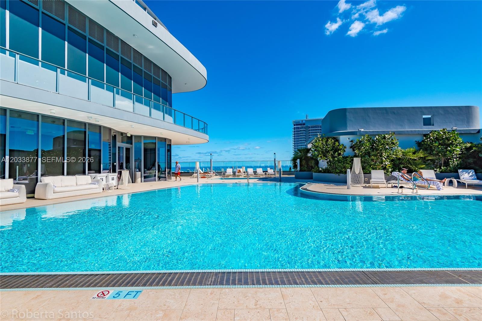 A modern outdoor swimming pool with lounge chairs sits on a building terrace — 1000 Brickell Plaza # 4509, Miami FL 33131, MIAMI, FL
