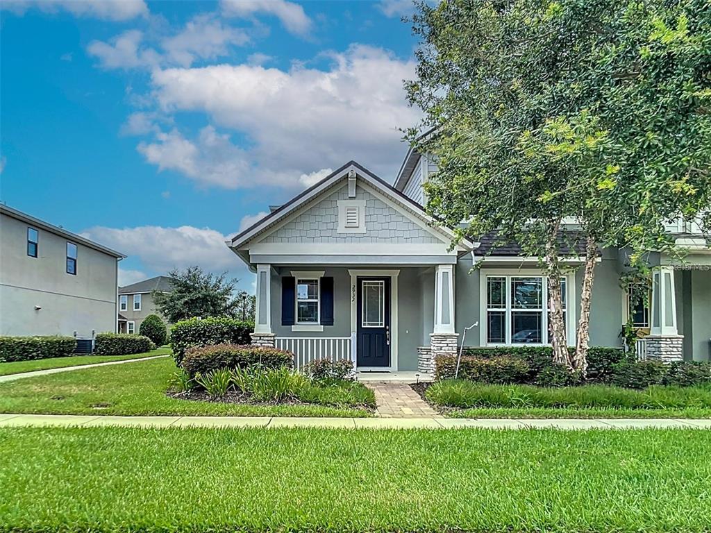 A single-story house with a gray exterior, white trim, and a covered front porch — 2932 CELLO LANE, KISSIMMEE, FL