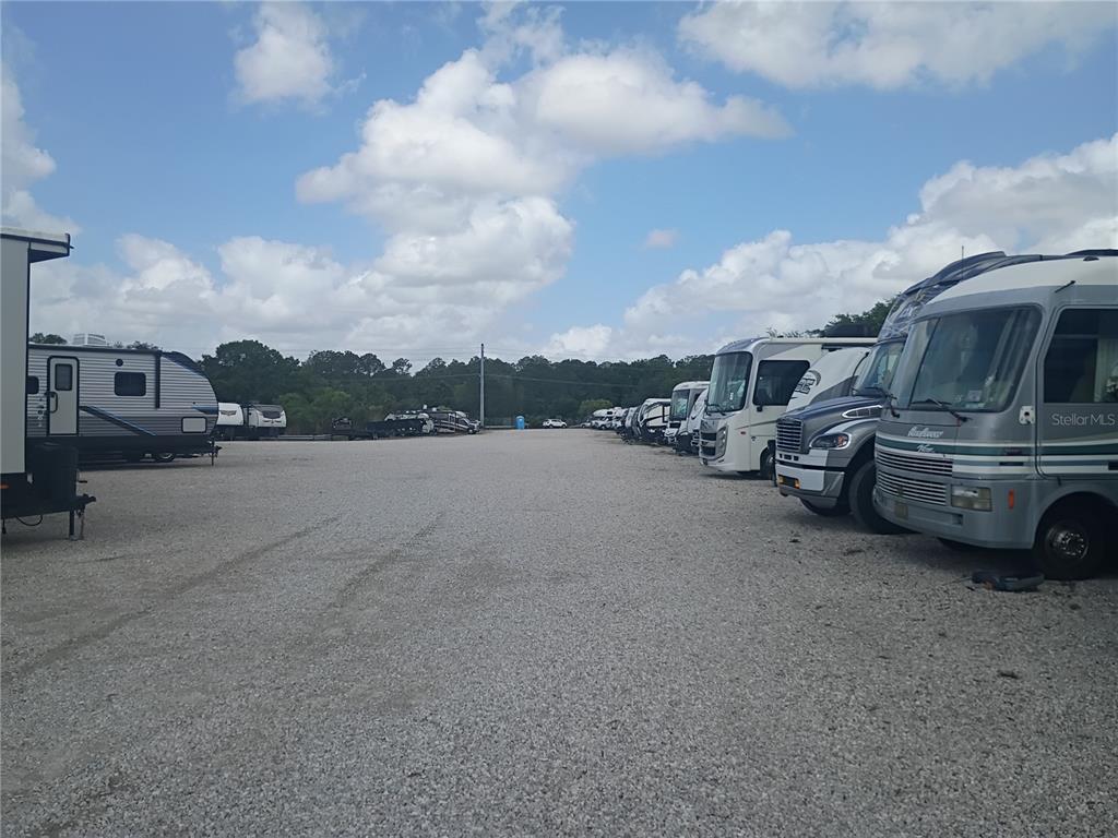 A gravel lot filled with numerous parked recreational vehicles under a cloudy blue sky — 0 STATE ROAD 33 N, LAKELAND, FL