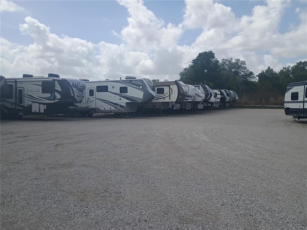 A row of recreational vehicles is parked on a gravel lot under a cloudy sky — 0 STATE ROAD 33 N, LAKELAND, FL