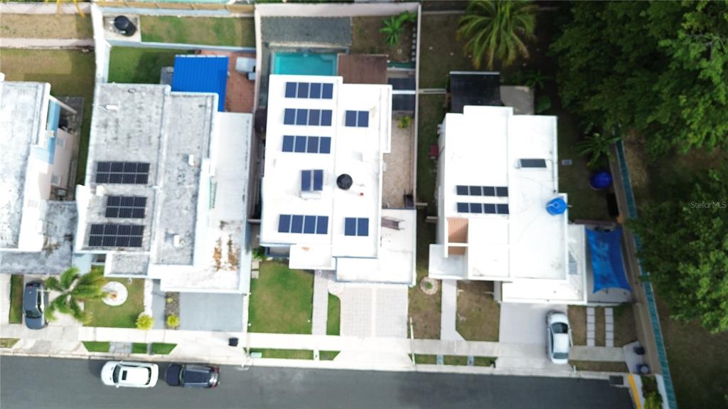 An aerial view shows three residential houses with flat roofs and solar panels — Estancias de Bairoa CALLE MIRAMELINDA, CAGUAS, PR