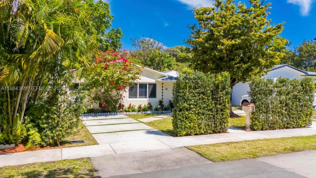 A single-story house with a white exterior, a concrete driveway, and lush landscaping — 222 SW 7th St, Dania Beach FL 33004, DANIA BEACH, FL