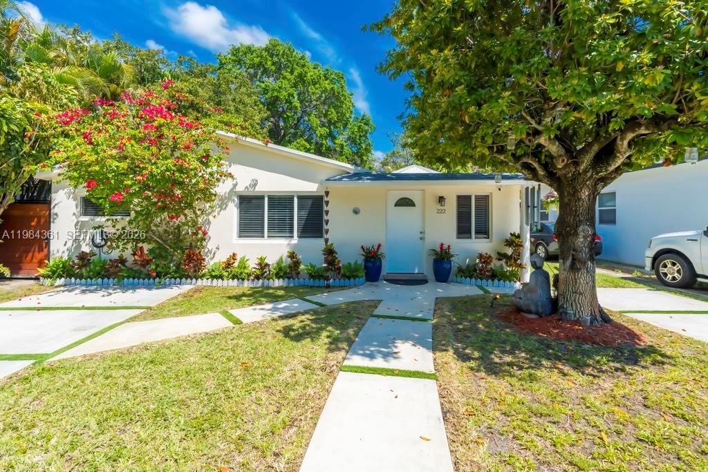 A single-story house with a white exterior, a front walkway, and a large shade tree — 222 SW 7th St, Dania Beach FL 33004, DANIA BEACH, FL