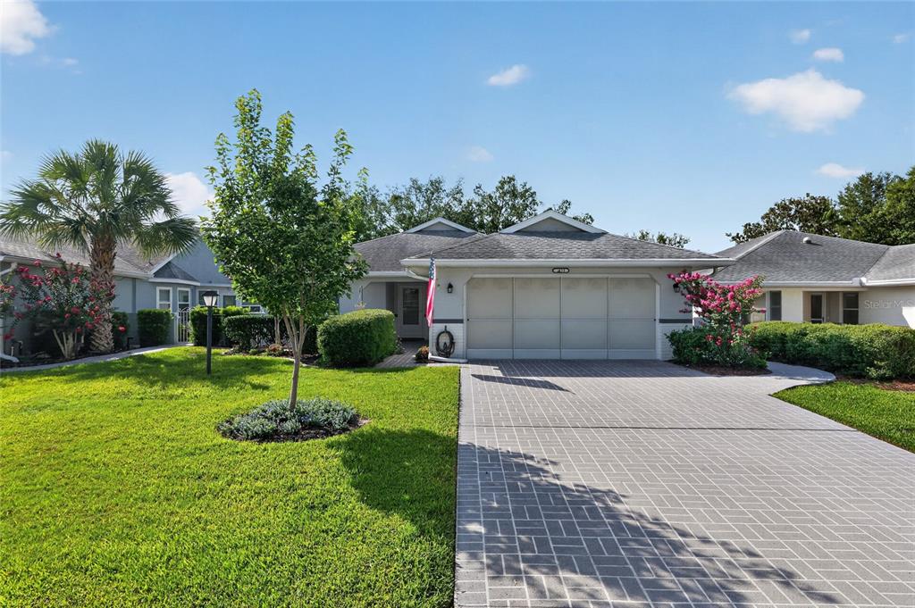 A single-story house with a paved driveway, a two-car garage, and a front lawn — 9153 SW 91ST TERRACE, OCALA, FL