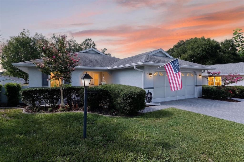 A single-story house with a two-car garage, a paved driveway, and a front lawn — 9153 SW 91ST TERRACE, OCALA, FL