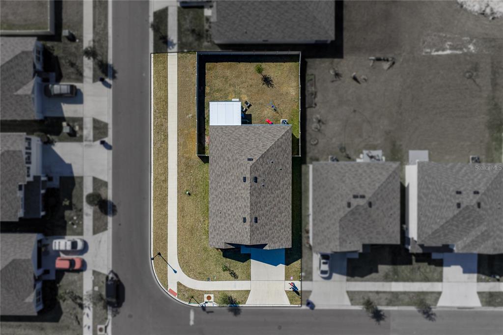 An aerial view shows a single-family home with a fenced backyard on a corner lot — 2741 GARDINER LANE, ZEPHYRHILLS, FL
