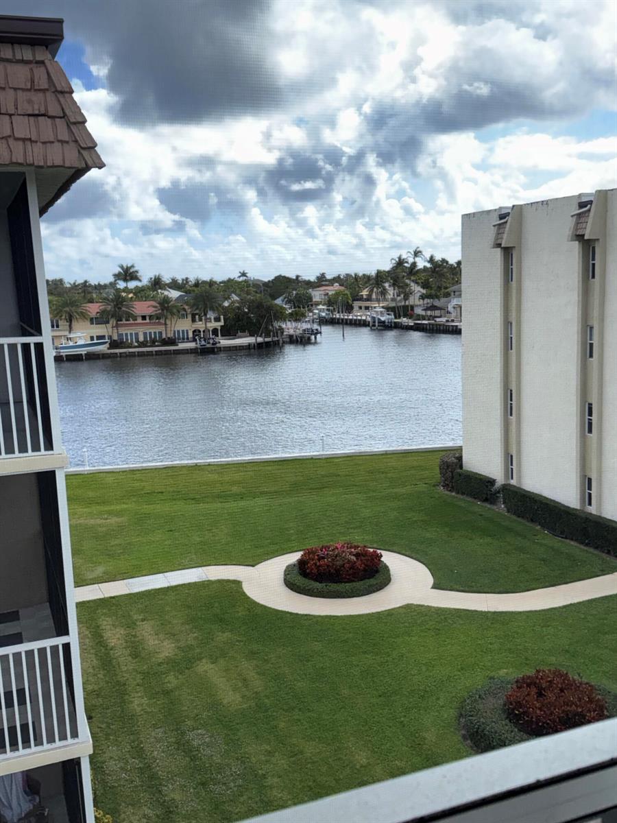 A kitchen features stainless steel appliances, white cabinets, and light wood-look flooring — 650 Snug Harbor Drive # G407, Boynton Beach FL 33435, BOYNTON BEACH, FL