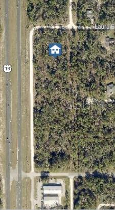 This is an aerial map view of a vacant, wooded lot next to a highway — 17496 NICASIO JAY AVENUE, WEEKI WACHEE, FL