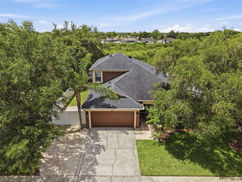 An aerial view of a two-story house with a dark shingled roof and garage — 22536 LAURELDALE DRIVE, LUTZ, FL