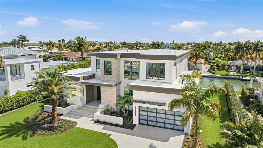 An aerial view of a modern two-story house with a stone facade and a garage — 530 CHIPPING LANE, LONGBOAT KEY, FL