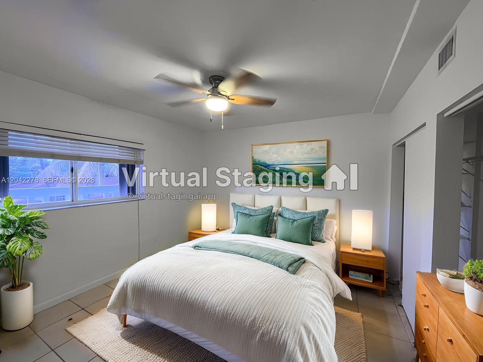 This bedroom features a queen bed, two nightstands, a ceiling fan, and a window — 1185 Marseille Dr # 309, Miami Beach FL 33141, MIAMI BEACH, FL