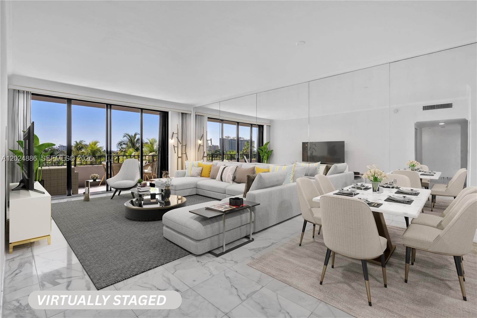 This virtually staged living and dining room features marble floors, mirrored walls, and a balcony — 151 Crandon Blvd # 441, Key Biscayne FL 33149, KEY BISCAYNE, FL