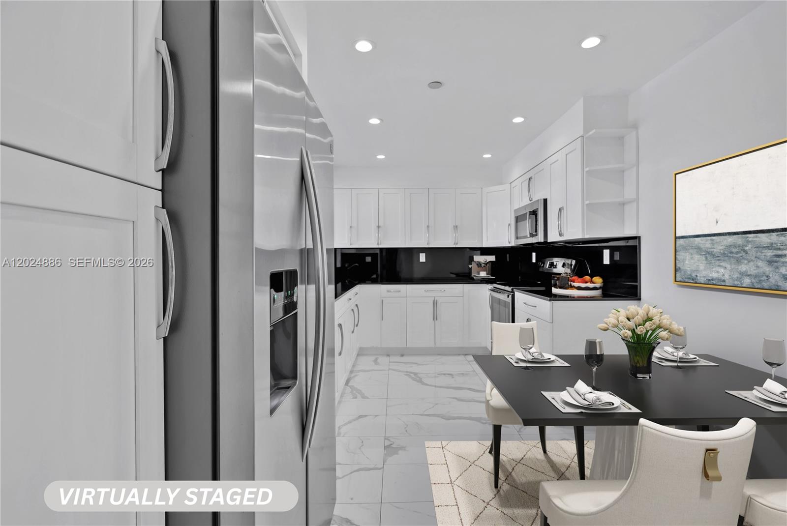 This kitchen features white cabinetry, a black backsplash, stainless steel appliances, and a dining area — 151 Crandon Blvd # 441, Key Biscayne FL 33149, KEY BISCAYNE, FL
