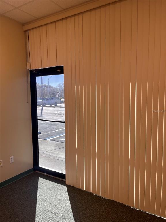 An interior office space features a glass door and floor-to-ceiling vertical blinds — 5999 DUNDEE ROAD UNIT 800, WINTER HAVEN, FL