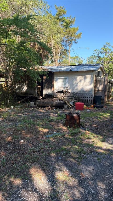 A weathered, single-story house with a brick exterior stands on a dirt lot — 6601 RIVERSIDE DRIVE, YANKEETOWN, FL